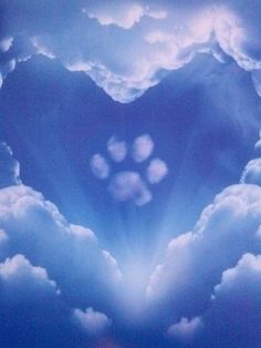 a heart shaped cloud formation in the middle of blue sky with white clouds surrounding it