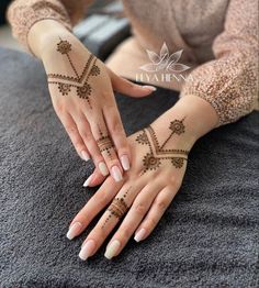 a woman with henna tattoos on her hands