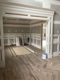 an empty room with hard wood flooring and white paint on the walls in it