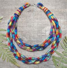 Totally hand woven colorful rope necklace to make you feel special and unique. Beautiful shades of interpenetrating colors will add energy to your outfits. Necklace is soft and lightweight. This braided statement necklace is eco - friendly. I mix different ends of yarn to create unique  organic fiber jewelry. All woven cords are the effect of work of my hands .  Each necklace in this series is one of a kind and unique. The color arrangement may be slightly different than in the photo, but it is still made of the same yarns. >>I hope that my jewelry introduced even a little magic and made you smile more often  << DETAILS: - Colors - multicolor - 100% eco friendly, zero waste and slow  - Very light to wear - Ready to send - travels in eco packaging ready for a gift  Production method: sewn b Color Arrangement, African Inspired Jewelry, Textile Necklace, Fabric Bracelets, Eco Packaging, Cord Jewelry, Boho Fabric, Wooden Bracelet, Fiber Jewelry