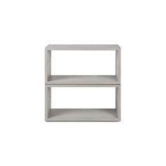 a white shelf with two shelves on each side and one shelf in the middle, against a