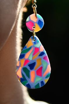 Fiesta Dangles | These festive, multi-colored earrings with translucent colors give a bit of a stained glass effect.  Handmade with polymer clay, including nickel-free iron jump rings and fishhook earring posts. **All items are handmade, so please keep in mind that small details may vary. A truly unique piece, made custom made just for you.** Multicolor Teardrop Whimsical Jewelry, Festive Multicolor Hand-painted Jewelry, Playful Hand Painted Multicolor Jewelry, Multicolor Resin Earrings For Pierced Ears, Quirky Multicolor Handmade Earrings, Playful Multicolor Resin Jewelry, Multicolor Polymer Clay Earrings, Multicolor Resin Dangle Jewelry, Whimsical Multicolor Polymer Clay Earrings