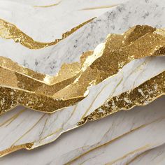 an abstract white and gold marble background with golden foiling on the top part of it