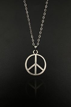 Step into a world of tranquility and serenity with our Peace Sign Necklace. This beautifully handcrafted necklace is perfect for both men and women, embodying the universal symbol of peace in a stylish and elegant manner. Whether you're a lover of all things boho or a dedicated follower of the hippie culture, our Peace Symbol Necklace is designed to resonate with your unique spirit and style. Embrace peace, radiate love, and express your unique style with our Peace Sign Necklace. This isn't just Bohemian Peace Sign Necklace For Gift, Vintage Jewelry With Peace Sign As Gift, Vintage Jewelry With Peace Sign For Gift, Symbolic Silver Jewelry With Peace Sign, Vintage Peace Sign Jewelry Gift, Symbolic Handmade Everyday Necklace, Everyday Symbolic Handmade Necklace, Silver Peace Sign Jewelry Gift, Symbolic Round Peace Sign Jewelry