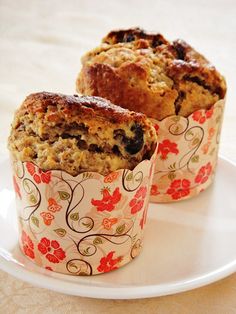 two muffins sitting on top of a white plate