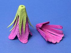 two paper flowers on a blue background