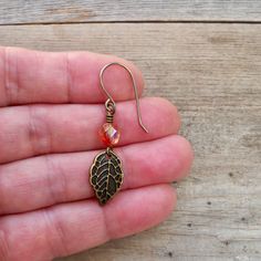 The perfect fall earrings with pure titanium ear wire (or your choice of antique brass ear wire). These are sure to be a quick favorite and time of the year. The bead is a yellow and pink bead that looks orange when the colors blend. Love these little 6mm beads. You can find them on other items in my shop, as shown in a few of the photos. The leaf is a beautifully detailed, antique brass leaf. It is 9x16mm. Titanium is great for even the most sensitive ears. Titanium is a pure metal, not an allo Copper Dangle Crystal Earrings For Gift, Vintage Brass Hypoallergenic Earrings, Nickel-free Leaf-shaped Brass Jewelry, Hypoallergenic Vintage Brass Earrings, Vintage Hypoallergenic Brass Earrings, Antique Gold Copper Earrings Nickel Free, Nickel-free Antique Gold Copper Earrings, Antique Gold Nickel-free Copper Earrings, Hypoallergenic Bronze Brass Earrings