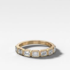 an 18k gold band with baguettes and diamonds