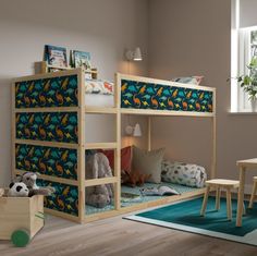 a child's bedroom with bunk beds and toys on the floor in front of it