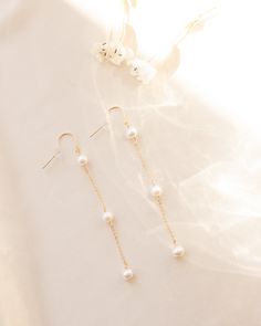 Inspired by bridal season, these freshwater pearl dangle earrings are the perfect statement piece. 3 sweet fresh water pearls embellished down our favorite sparkly chain for the most delicate accent. Details: -Gold Filled, Sterling Silver -3 freshwater pearls, 6mm in size -Drop of earring is 2.5 inches -Waterproof, Tarnish Resistant, Hypoallergenic Pearl Dangle Earrings, Fresh Water Pearls, Water Pearls, Pearl Earrings Dangle, Sterling Silver Earrings, Fresh Water, Freshwater Pearls, Gold Earrings, Gold Filled