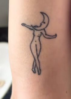 a woman's arm with a tattoo on it that has an image of a person holding a knife