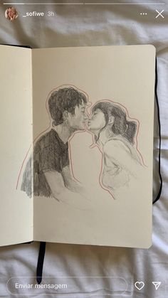 an open notebook with a drawing of two people kissing