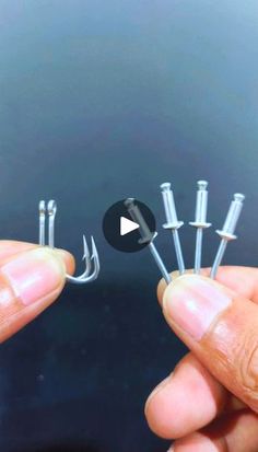 someone is holding several screws in their hands