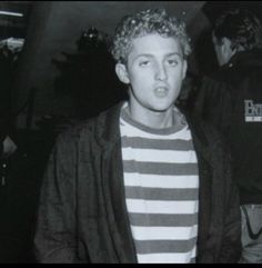 black and white photo of young man in striped shirt