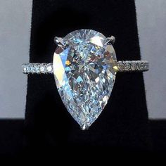 an engagement ring with a pear shaped diamond