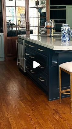 a kitchen with an island and stools in it