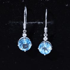 Product Details These elegant drop earrings feature stunning round shape swiss blue topaz stone, and shimmering Moissanite set in prong setting. The earrings are crafted in luxurious gold and hang from delicate fish hook backs, adding a touch of sophistication to any outfit. The beautiful blue topaz stone are offset by the glittering Moissanite, creating a mesmerizing and eye-catching look. These classic earrings are the perfect accessory for adding a pop of color and sparkle to any outfit, maki Earrings Hanging, Wedding Blue Topaz Drop Earrings, Blue Topaz Drop Earrings, Blue Tanzanite Drop Earrings, Blue Topaz Gemstone Dangle Earrings, Blue Tanzanite Round Earrings, Classic Earrings, Blue Topaz Stone, Topaz Stone