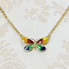 18K Yellow Gold Estate Enamel Butterfly Necklace. 16" Chain, Weighs 5.3 grams. Gold Enamel Necklace With Adjustable Chain, Yellow Gold Enamel Jewelry With Adjustable Chain, Multicolor Enamel Pendant Necklaces, Multicolor Enamel Pendant Necklace, Yellow Gold Enamel Necklace For Gift, Multicolor Hand Painted Enamel Necklaces, Hand Painted Multicolor Enamel Necklaces, Gold Enamel Pendant Necklace, Yellow Gold Necklaces With Black Enamel For Gift