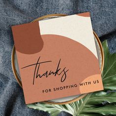 a thank card with the words thanks for shopping with us written on it next to some leaves