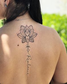 a woman with a lotus tattoo on her back