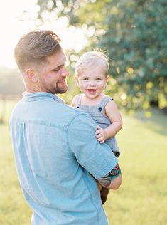 a man holding a small child in his arms