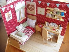 a doll house with a bed and desk in it