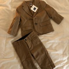 So Awesome!!! Brand New W/Tags 6-12 Mths Baby 2-Piece Suit In Camel/Light Brown. Wool And Polyester But Still Not Heavy. Light And Comfy. 2 Button 3 Pockets And Super Chic Baby Gear At It’s Finest! I Don’t Even Wanna Sell It It’s So Freakin Cute But My Kids Are Teenagers Lol!!!! Bought For Sister But Bought Too Small Duh!!!! - So Crazy She Couldn’t Use It!!!!! This Is Just Rad!! Fitted Brown Cotton Sets, Classic Cotton Beige Set, Classic Beige Cotton Set, Classic Brown Sets For Fall, Dinosaur Sweater, Coral Shorts, Fair Isle Cardigan