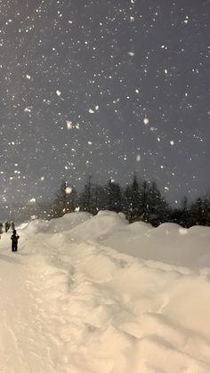 two people are walking through the snow on skis