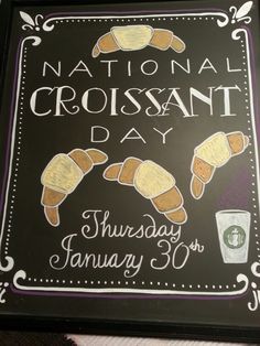 a chalkboard sign with croissants on it for national crossant day