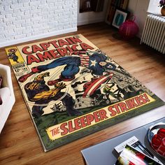 the captain america rug is on the floor next to a chair and table with books