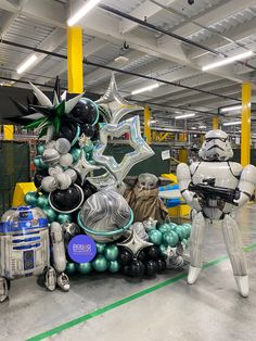 star wars balloon decorations are displayed in an indoor space with other balloons and toys on the floor