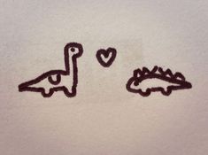 two stencils with hearts and dinosaurs drawn on them