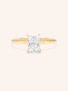 a gold ring with a princess cut diamond