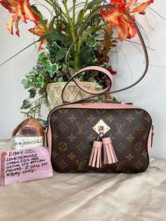 Louis Vuitton Monogram Saintonge with Rose Ballerine Pink This little shoulder/crossbody bag is perfectly sized! Measurements are 8.5" x 5.57" x 3" with a 22.5" drop.  Listing includes: LV Saintonge shoulder bag only. This adorable little bag has pink leather trim, shoulder strap, a pop up top handle and a pink front tassel.  The top zipper opens to pink fabric interior with a patch pocket.  Please supersize the photos as they are the best description of condition. The bag is in excellent preowned condition. There is slight creasing on the pink leather part of the bag. This is a preowned item. There are no major flaws, but since it is preowned, I find it easiest to say you may find slight creasing on the leather including the strap, possible corner rubbing, signs of use such as scuffing or Pink Monogram Canvas Rectangular Shoulder Bag, Pink Rectangular Monogram Canvas Shoulder Bag, Louis Vuitton Handbags Pink, Louis Vuitton Pink Bag, Pink Louie Vuttion Bag, Louis Vuitton Pink Strap Bag, Pink Crossbody Flap Bag With Gold-tone Hardware, Pink Crossbody Bag, Selling On Ebay