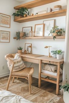 a desk with some plants and pictures on the wall above it, along with two chairs