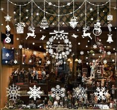 a window display with snowflakes and christmas decorations