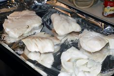 raw fish fillets on aluminum foil ready to be cooked in the oven for dinner