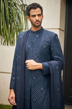 Navy blue sherwani with floral Mughal chikankari embroidery and sequin highlights. Comes with matching dupatta, short kurta and pant.
Components: 4
Pattern: Embroidered
Type Of Work: Chikankari, Sequins
Neckline: Mandarin
Sleeve Type: Straight Full
Fabric: Sherwani and Dupatta- Georgette, Kurta and Pant- Terrywool
Color: Blue
Other Details: 
Model height: 6ft, wearing size M
Occasion: Sangeet,Groom - Aza Fashions Eid Bandhgala With Chikankari Embroidery, Blue Unstitched Suit With Chikankari Embroidery For Reception, Blue Chikankari Embroidery Unstitched Suit For Reception, Blue Bandhgala With Chikankari Embroidery For Festive Occasions, Eid Bandhgala With Chikankari Embroidery In Jamawar, Designer Blue Bandhgala With Chikankari Embroidery, Blue Bandhgala With Chikankari Embroidery For Designer Wear, Blue Chikankari Embroidered Bandhgala For Reception, Semi-stitched Blue Sherwani With Cutdana