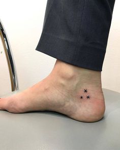 a person's foot with small stars on the bottom of their toe and ankle