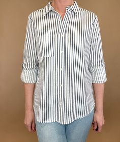 The Marina top is effortlessly beautiful with textured stripes, a split hem & a single chest pocket. Made from 100% cotton, this stylish striped shirt is versatile enough to pair with any casual denim and sandals or work wear. Let it be your go-to piece for classic, effortless fashion. Details: 100% Cotton Button up blouse Single front pocket Split hem Roll tab sleeves Fit: true to size, Amber is modeling size Small. Contents: 100% Cotton Imported Trendy Relaxed Fit Top With Vertical Stripes, Summer Day Out Shirt With Vertical Stripes, Vertical Stripes Shirt For Summer Day Out, Casual Summer Shirt With Contrast Stripes, Summer Shirt With Vertical Stripes For Day Out, Casual White Blouse With Vertical Stripes, Casual Vertical Stripes Blouse For Day Out, Vertical Stripes Relaxed Fit Top For Day Out, Relaxed Fit Vertical Stripes Top For Day Out