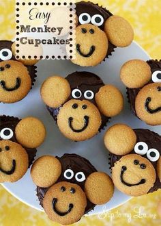 some cupcakes with eyes and noses on top of a white plate in the shape of monkeys