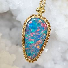 Like a petite object of art, this Australian opal doublet has a luxurious iridescence with flashes of reds, blues, and teals. The colorful gem is set within a meticulously hand-woven golden textile bezel with a closed-back setting. The pendant bail is adorned with beaded detail and hung on an adjustable fine gold chain. Appreciate this artistic beauty as a stand-alone necklace or layer with more of your favorite Amáli creations! Cold Hard Facts: metal: 18K yellow gold gems: (1) - Australian opal Montana Sapphire Ring, October Birthstone Jewelry, Pendant Bail, Bozeman Montana, Promise Ring Gift, Pendant Bails, Jewelry Appraisal, Celestial Jewelry, Sapphire Bracelet