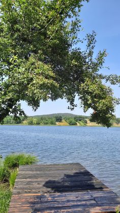 a wooden dock sitting next to a large body of water