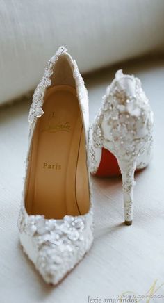 two pairs of white shoes with bows on the toes, one is decorated with sequins