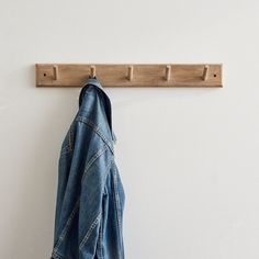 a denim jacket hanging on a coat rack