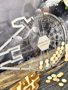 a star wars themed table setting with gold and silver decorations on it's side