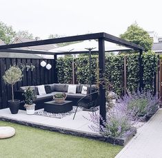 an outdoor living area with furniture and plants