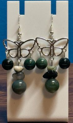 Beautiful moss agate dangle earrings. Made with sterling silver earwire and comes with earring backs. Be sure to check out the matching necklace and bracelet! I take pride in my work so if there are ever any problems with this piece, please let me know so we can get it fixed! I make one of a kind jewelry that will stand out! Will ship Quickly!! Natural Stone Jade Dangle Earrings, Hypoallergenic Agate Round Beads Jewelry, Aventurine Dangle Earrings For Gift, Silver Agate Drop Earrings, Nickel-free Agate Jewelry For Healing, Silver Agate Jewelry With Matching Earrings, Spiritual Jade Dangle Earrings, Handmade Green Agate Earrings, Green Moss Agate Earrings For Gift