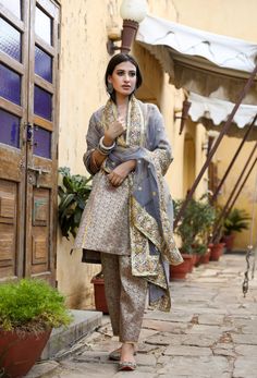 The set consists of straight cut handwork printed kurta with gota detailing, 3/4th sleeves, round neck, knee length teamed with printed trouser and a dupatta with border. Suit Fabric-Georgette Dupatta Fabric-Organza Kurta length - 40 in Pants length - 38 in Model is wearing size small. She is 5.8” tall. Washing Care-Dry Clean Organza Kurta, Georgette Dupatta, Grey Suit, Gray Suit, Suit Fabric, Suit Set, Pants Length, Raw Silk, Straight Cut