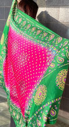 This bright pink and green shawl is beautifully decorated with golden dots and colorful peacock feather designs along the edges. It's light and can be worn in many different ways, perfect for adding a pop of color to any outfit. Great for special events or everyday wear, this shawl brings a touch of Afghan style to your look. Afghan Style, Green Shawl, Colorful Peacock, Feather Design, Green And Pink, Peacock Feather, Shawls And Wraps, Bright Pink, Traditional Style